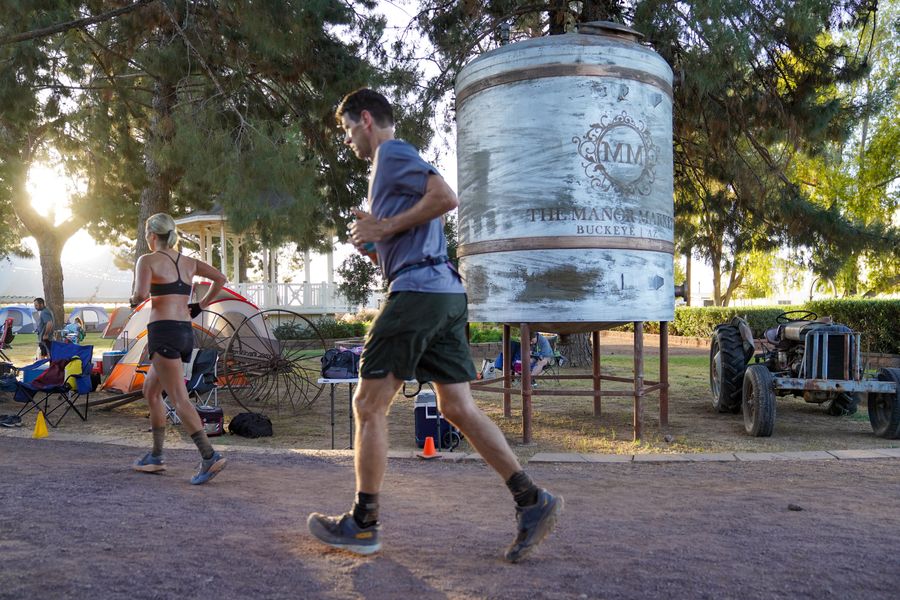 Runners by the old water tank at sunrise